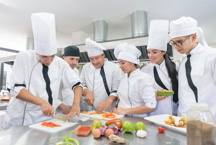 Group of people in a cooking class Happy group of young Latin American people in a cooking class